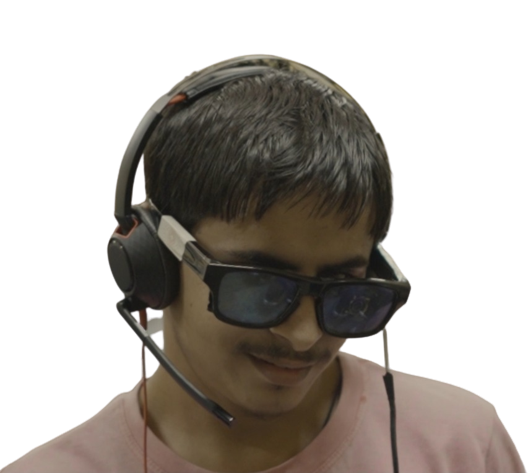 A person using the Drishti glasses with a dot background